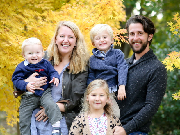 Lulu and Brendan Manley standing outdoors with their children