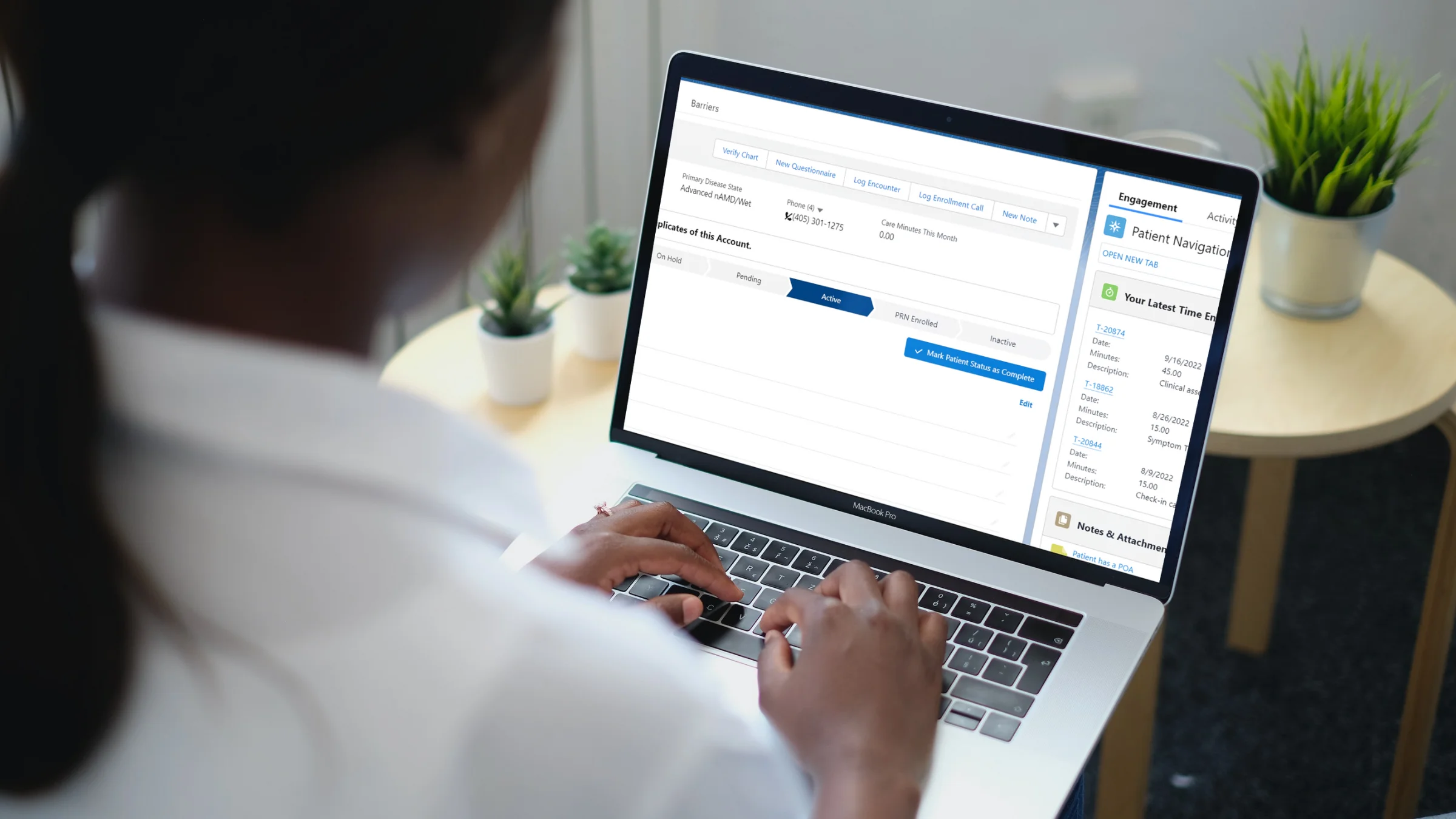 Lumata promotional photograph of a person reviewing the care-management dashboard on a laptop