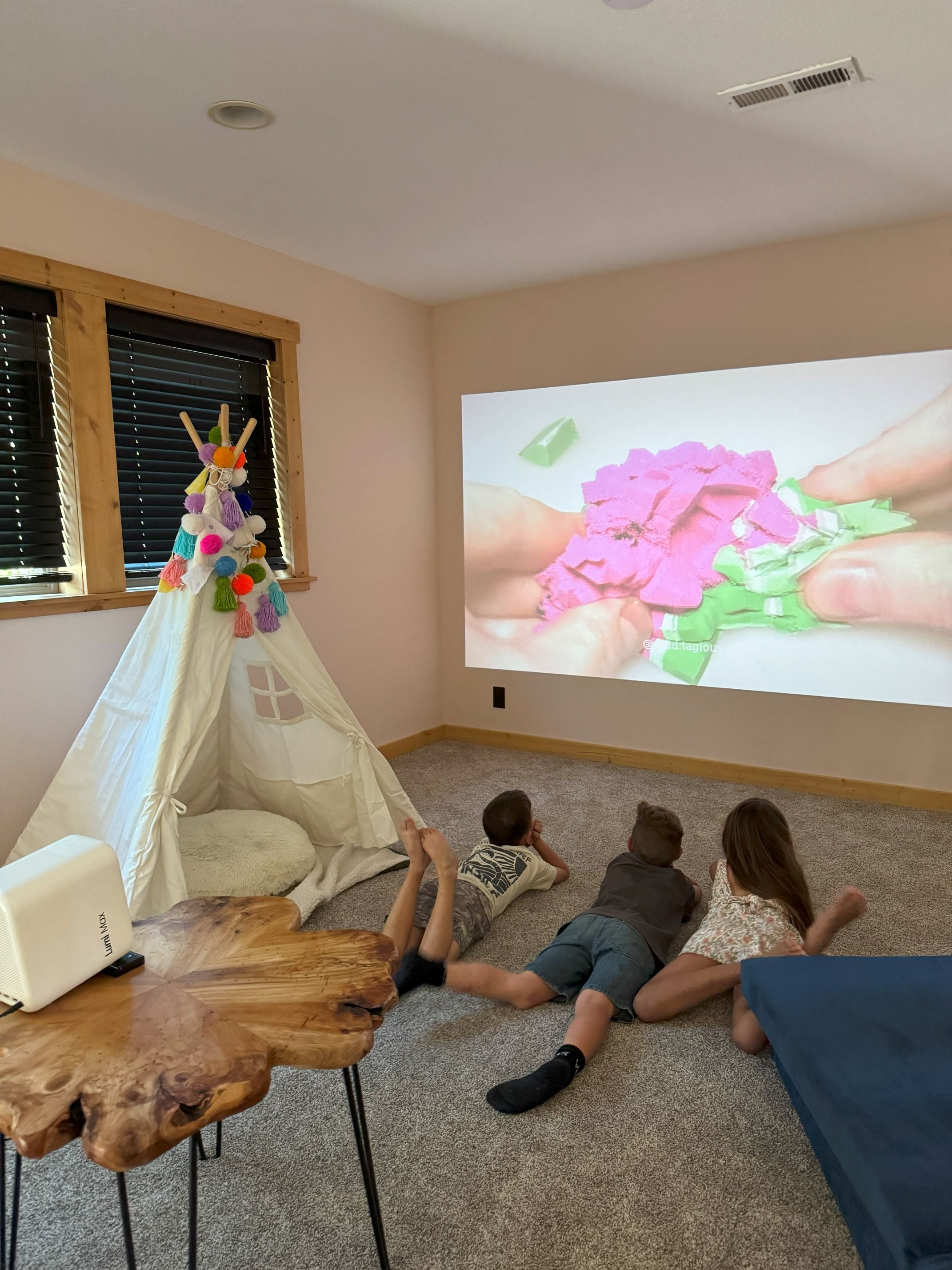 Children watching content on a large projected screen at home