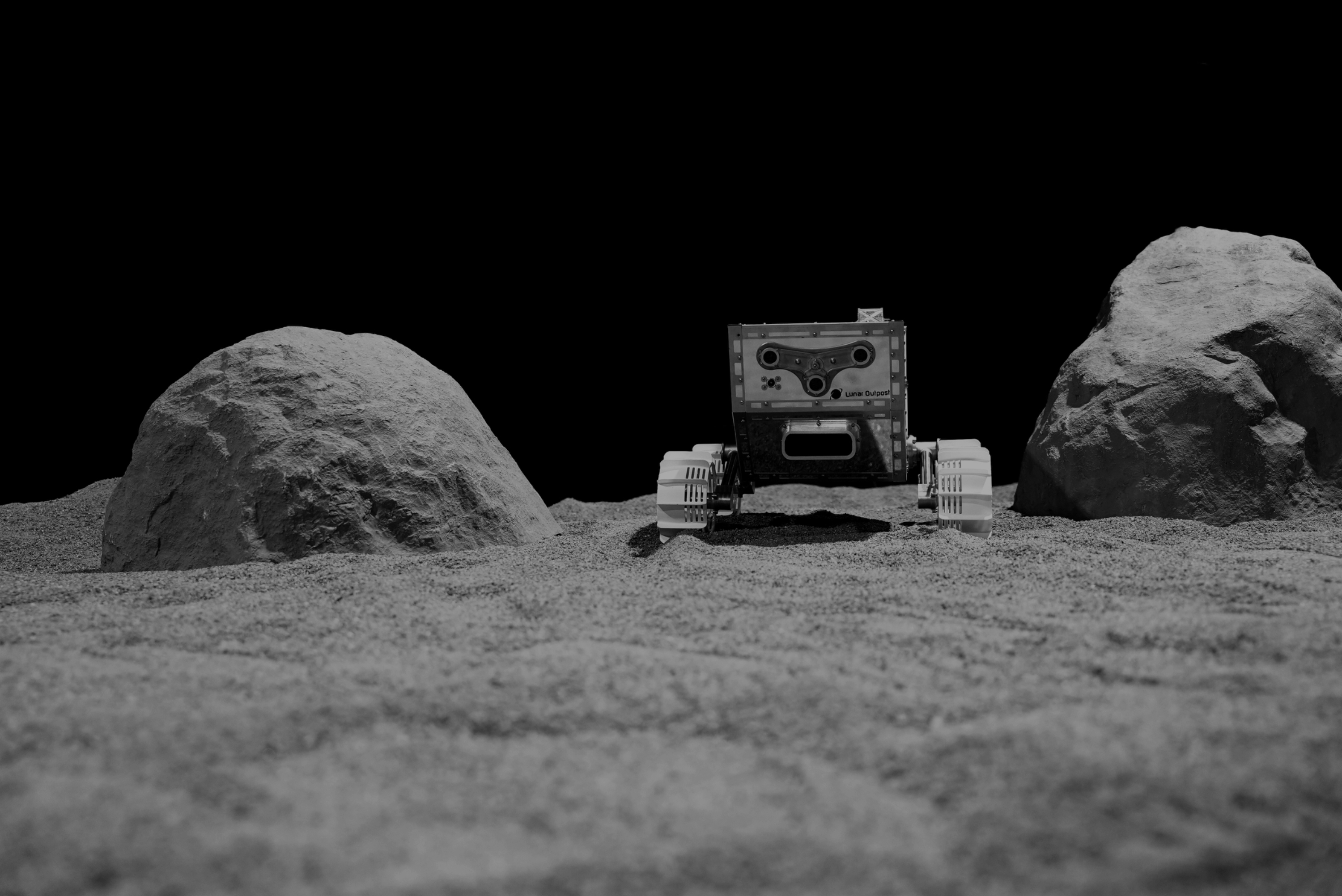 Company promotional view of a four-wheeled MAPP rover among rocks