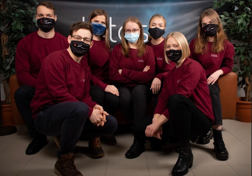 Seven members of the 2021 LUTES board wearing burgundy tops and face masks