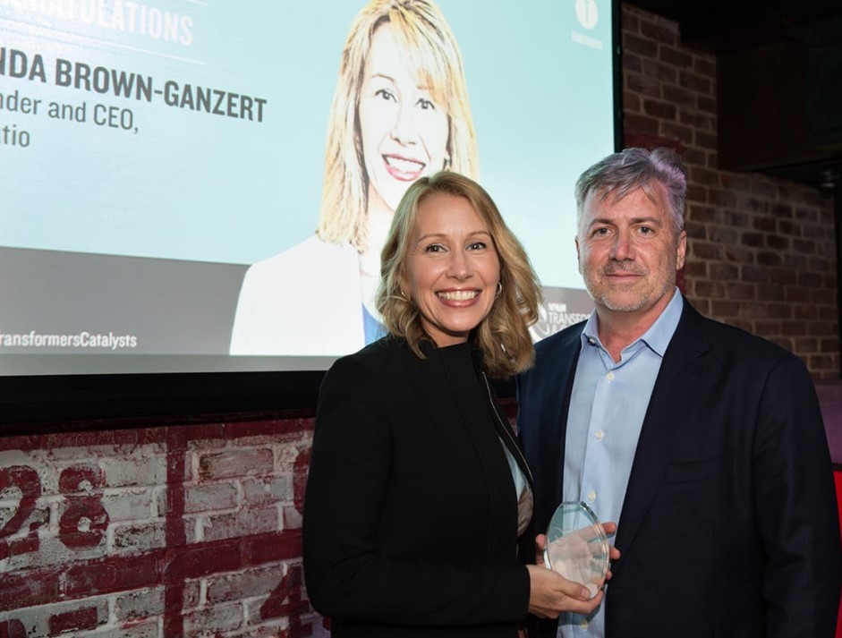 Lynda Brown-Ganzert holding an award at an industry event