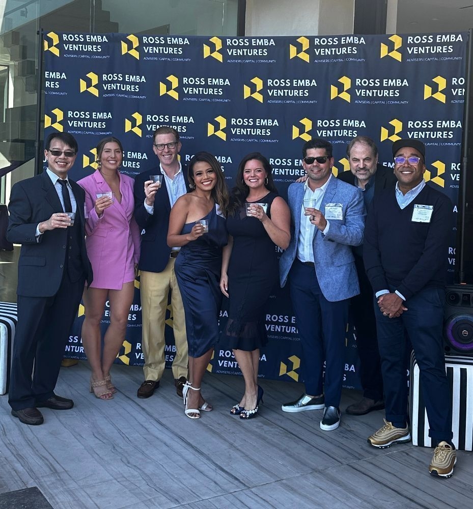 Lynn Fernando with fellow attendees in front of a Ross EMBA Ventures backdrop
