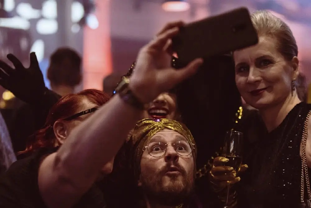 People posing together for a phone photograph in an image from M-Files’ careers page