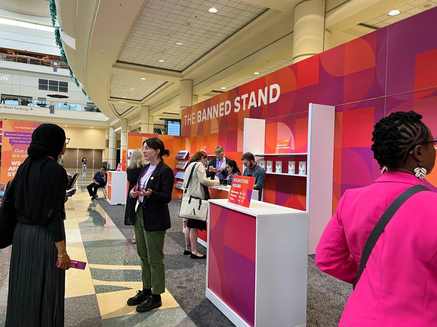 People browsing the Banned Stand bookstore installation at a convention