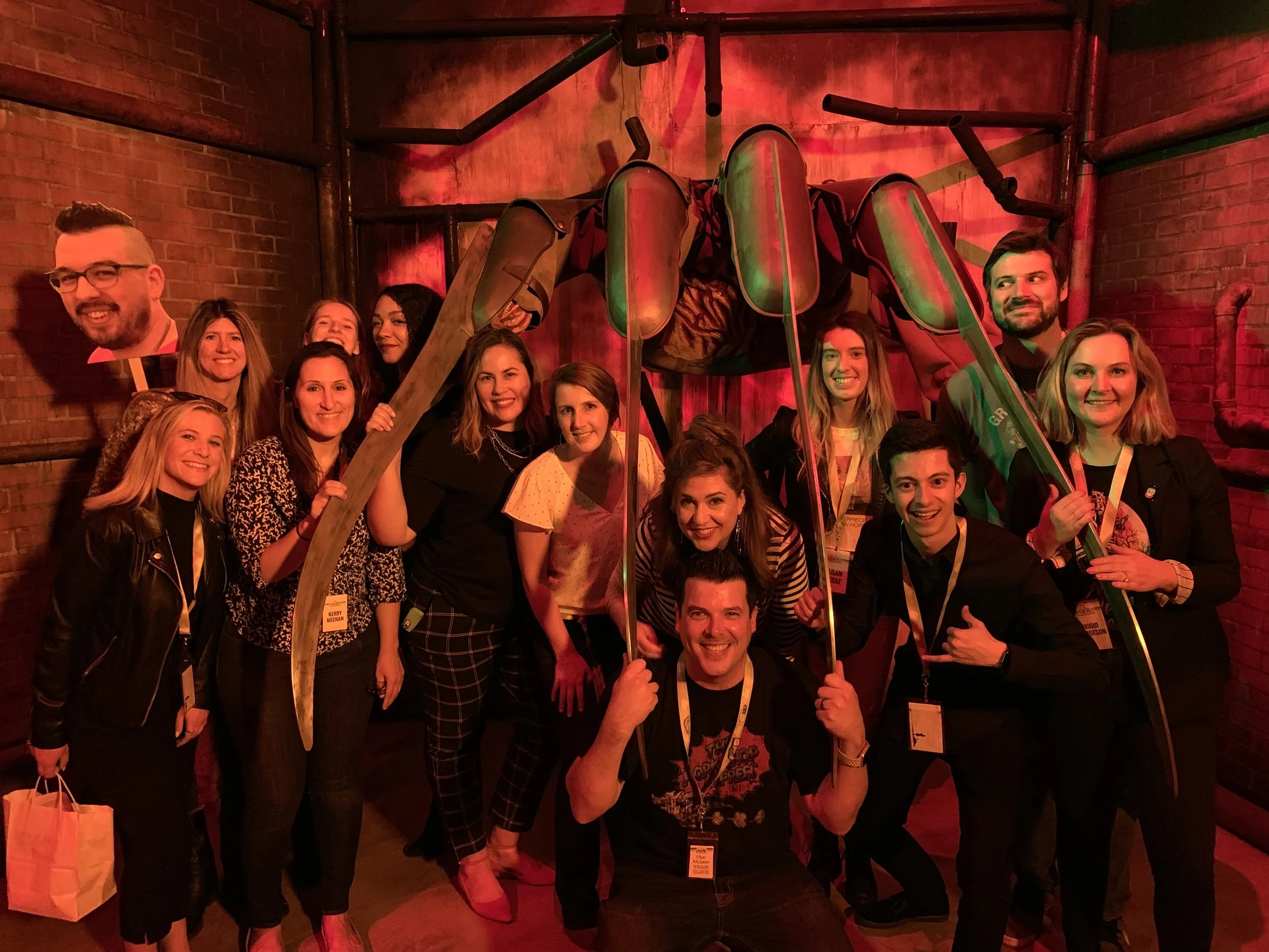 Team Click colleagues pose beneath an oversized Freddy Krueger glove at the I Like Scary Movies Experience.