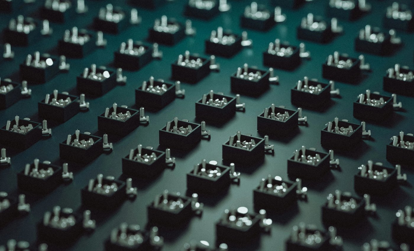 A field of small dark electronic components photographed for Machinify's brand imagery