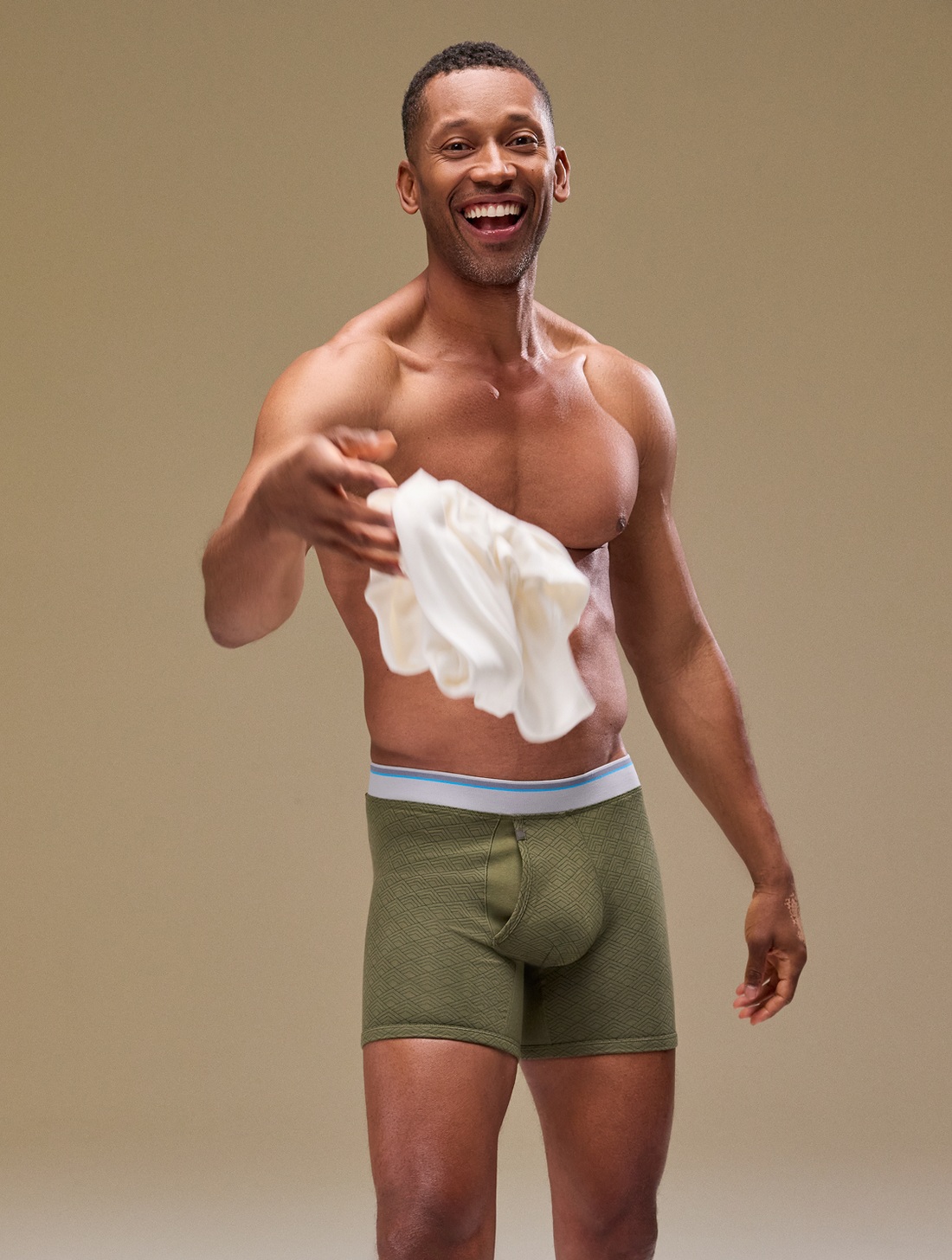 Mack Weldon campaign model tossing a shirt while wearing underwear