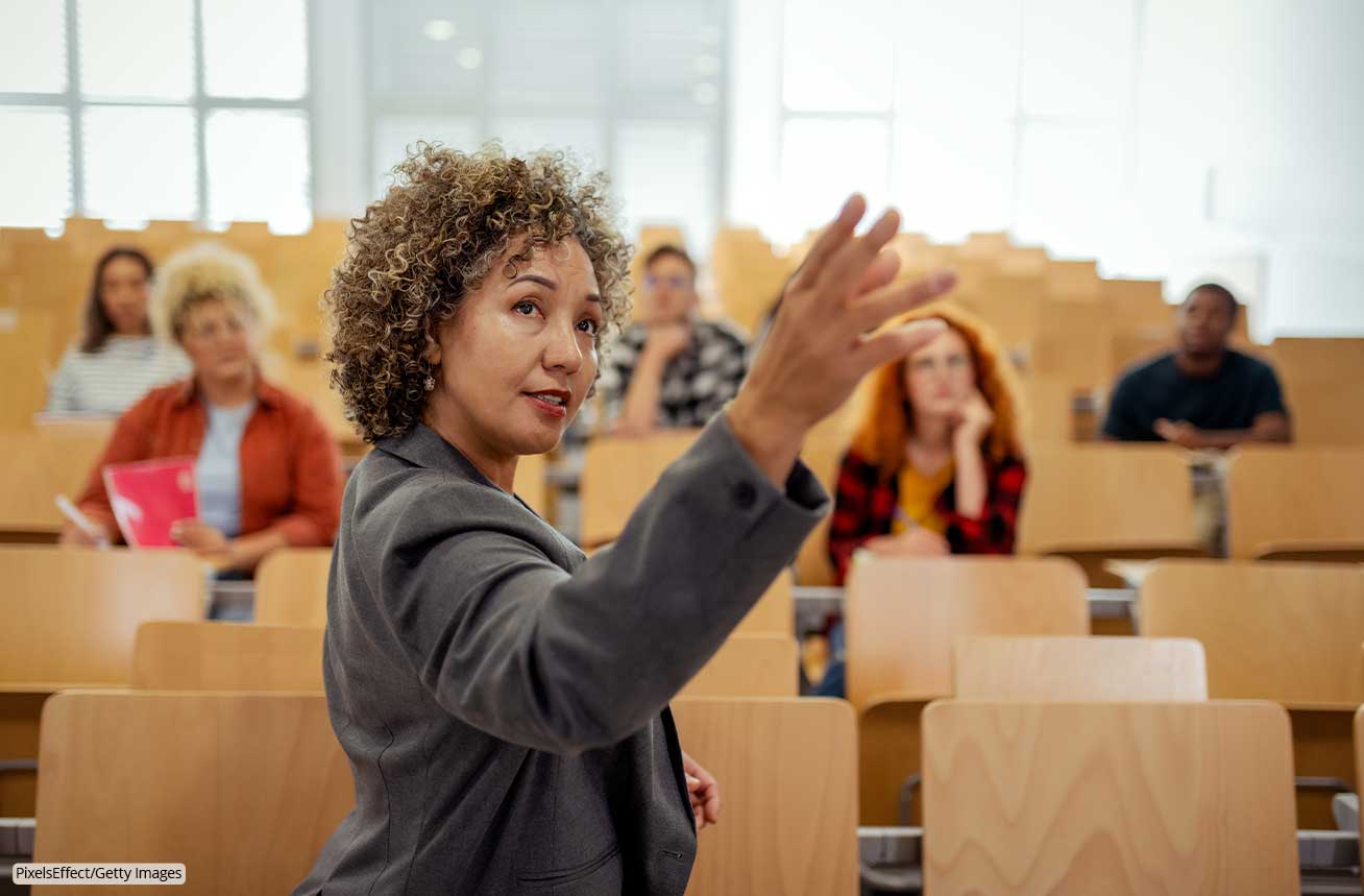 An instructor gestures while talking with students in a classroom, from official iClicker marketing materials