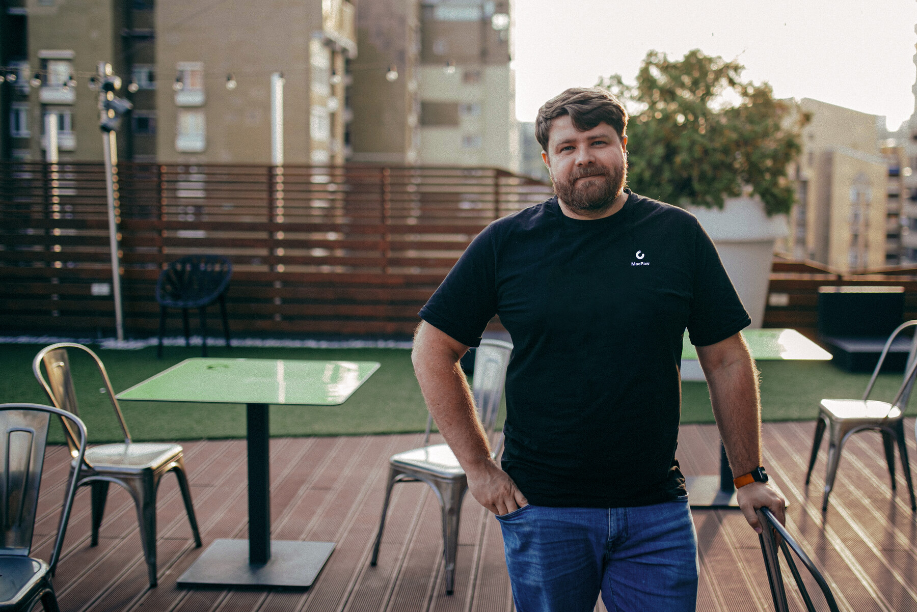 MacPaw founder Oleksandr Kosovan standing on an office terrace in Kyiv