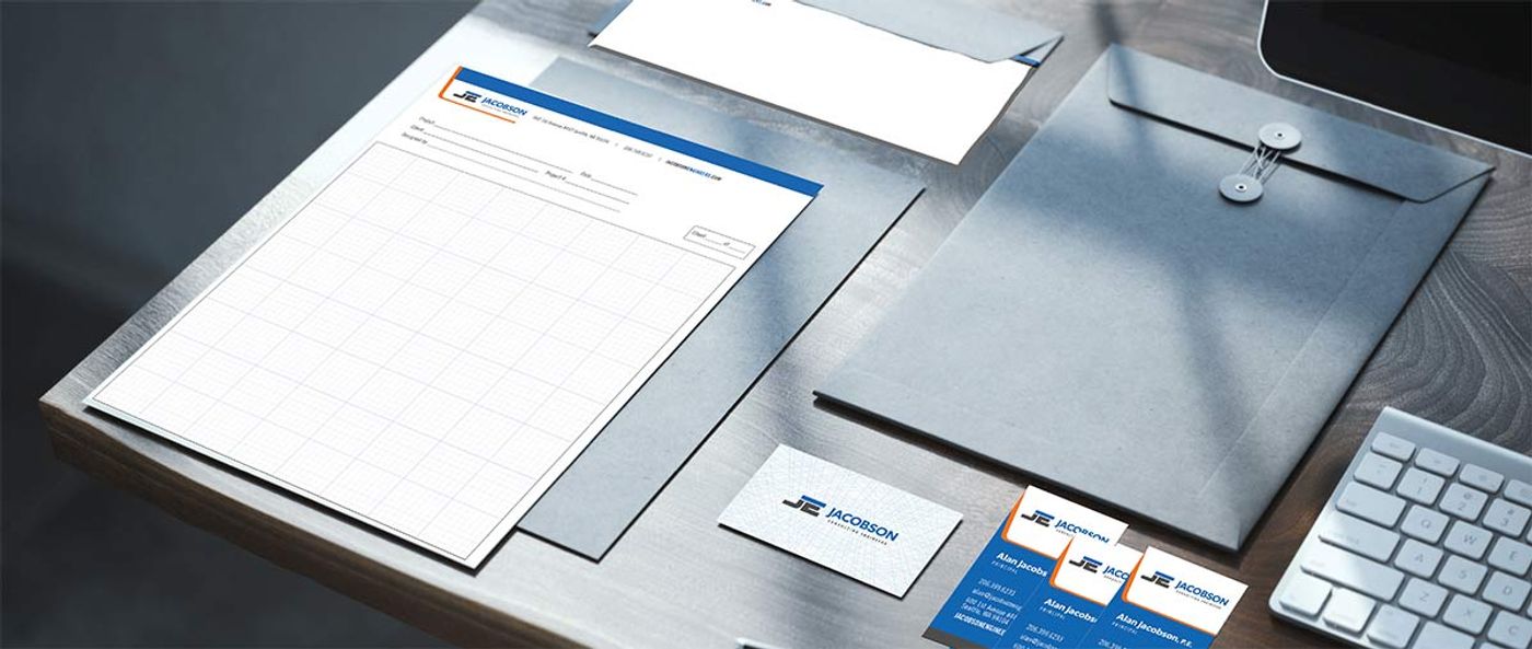 Jacobson Consulting Engineers stationery and business cards designed in blue, orange, white, and charcoal