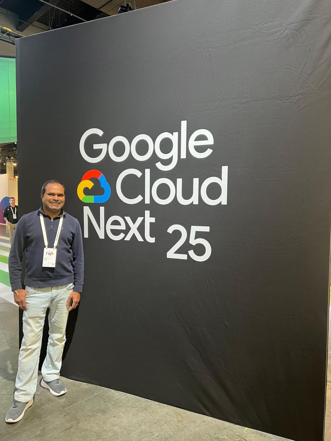 Madhava Kota beside the Google Cloud Next 25 event sign