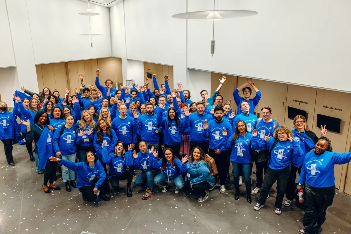 MaestroQA team gathered in matching blue sweatshirts