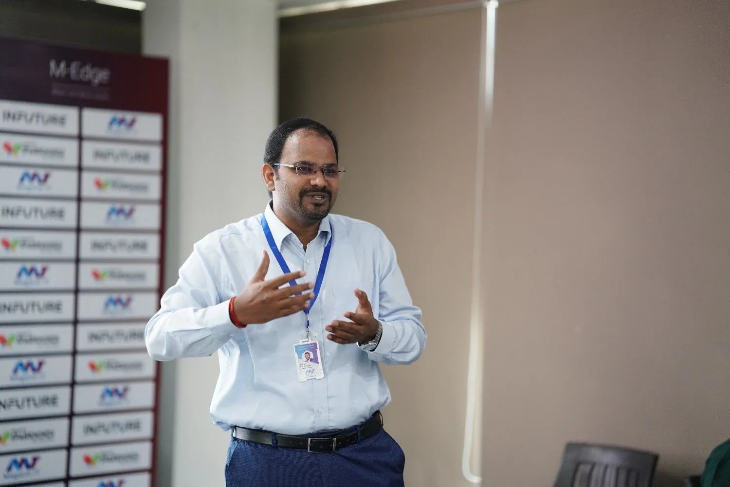 A speaker gesturing during an event pictured in Maganti IT Resources’ event gallery