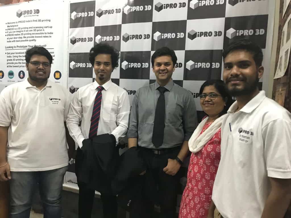 IPRO3D founder Yogesh Pawar, far left, with collaborators in front of an IPRO3D backdrop