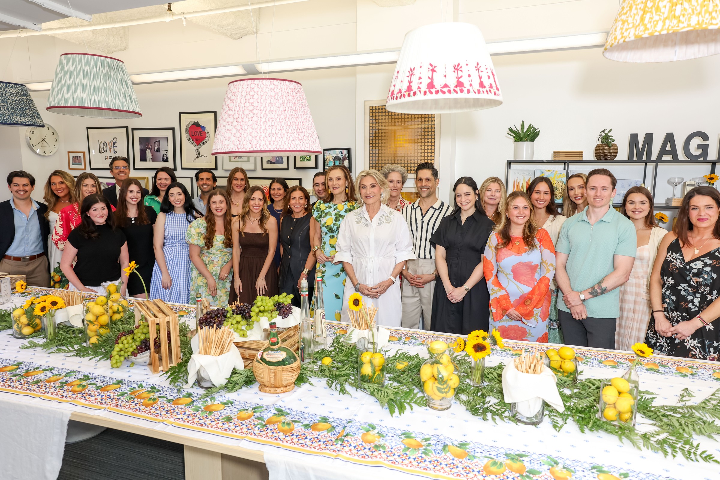 The Magrino team gathered in its New York office around a long table decorated with lemons, sunflowers and grapes