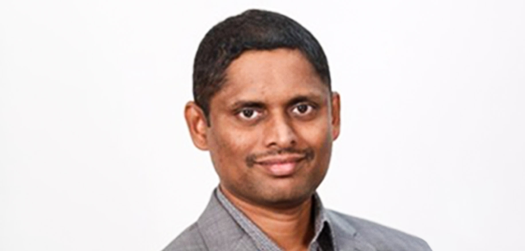 Mahendra Alladi wearing a gray shirt in an ACCELQ press photograph