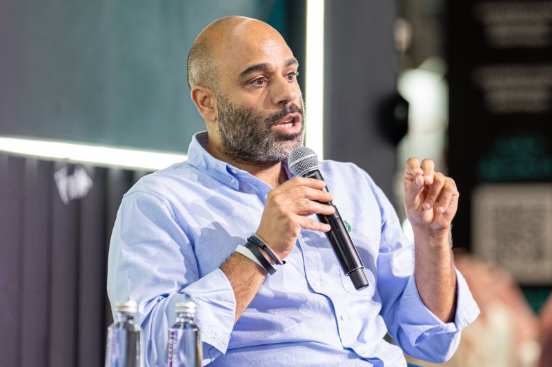 Maher Loubieh speaking into a microphone at the 24Fintech conference