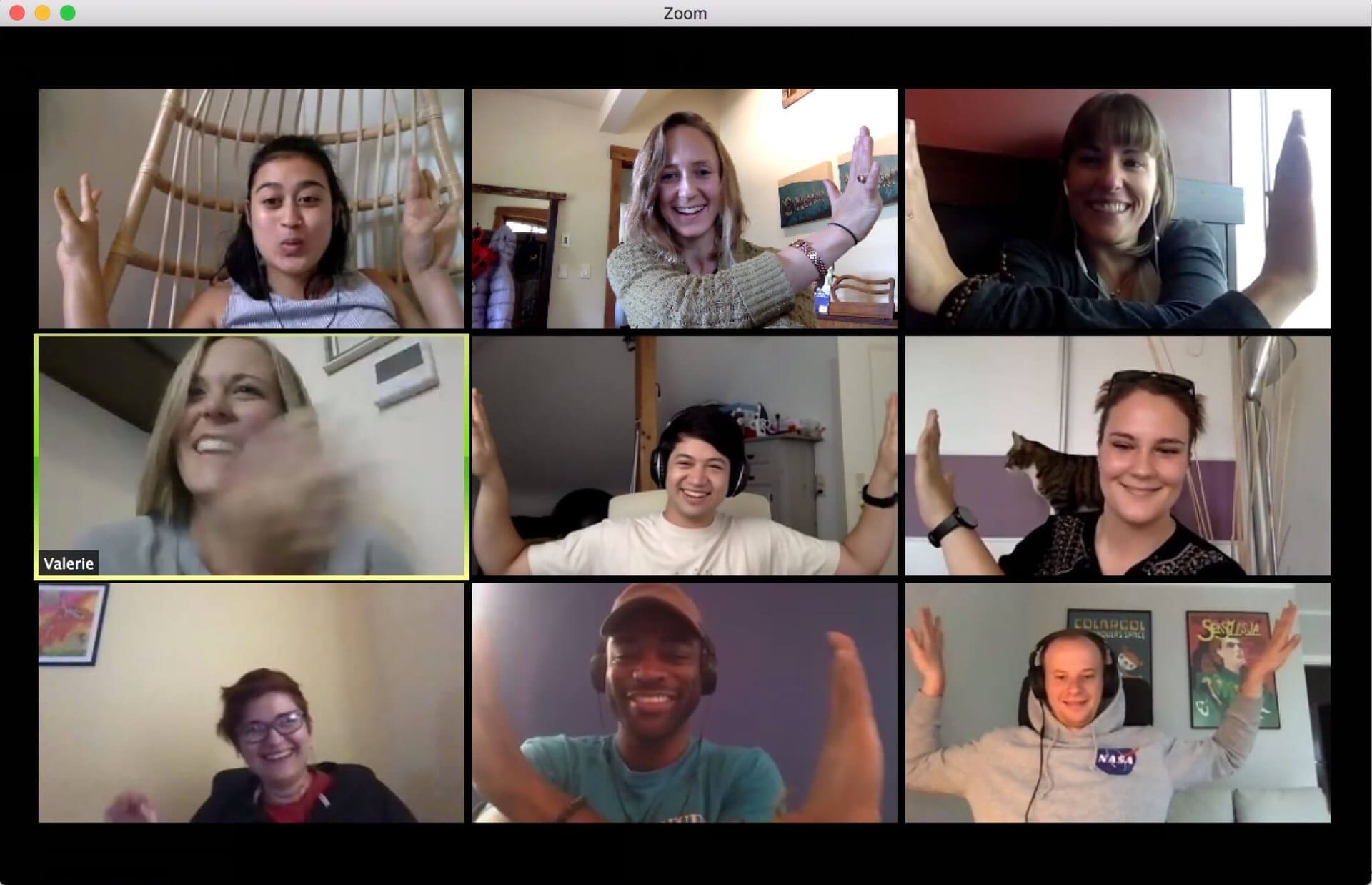 Maiya Holliday and eight colleagues smiling and gesturing during a Mangrove video call
