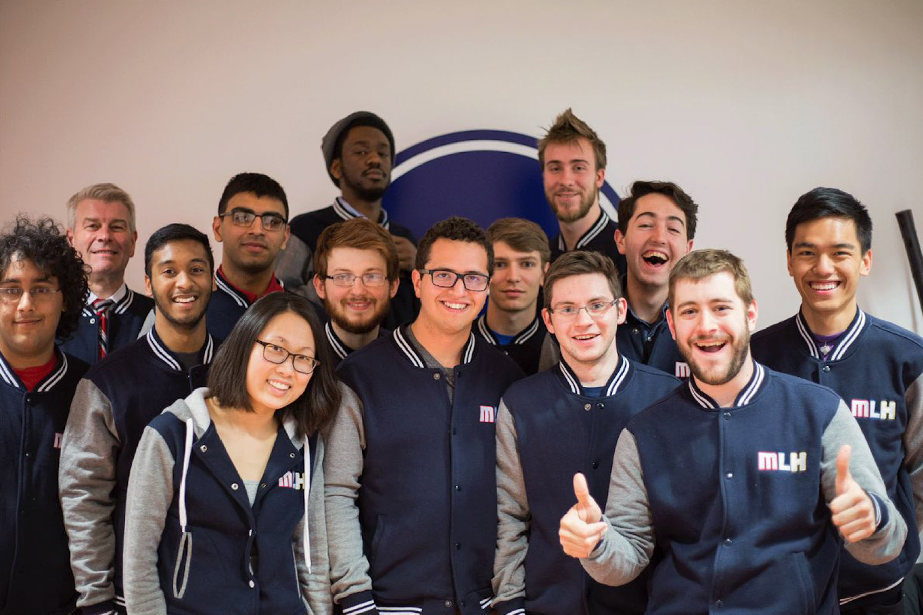 Major League Hacking team members wearing matching MLH jackets