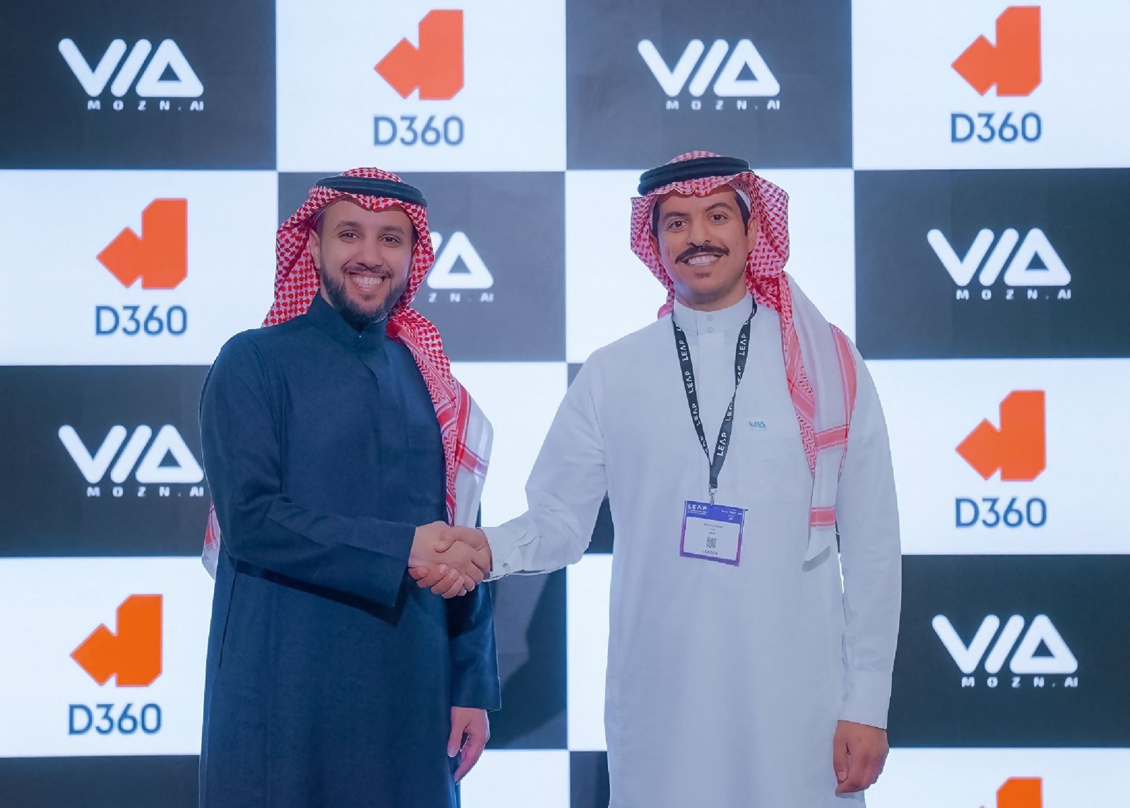 Malik Alyousef, right, shakes hands with Osama Al-Shathri at the Mozn and D360 Bank partnership announcement.