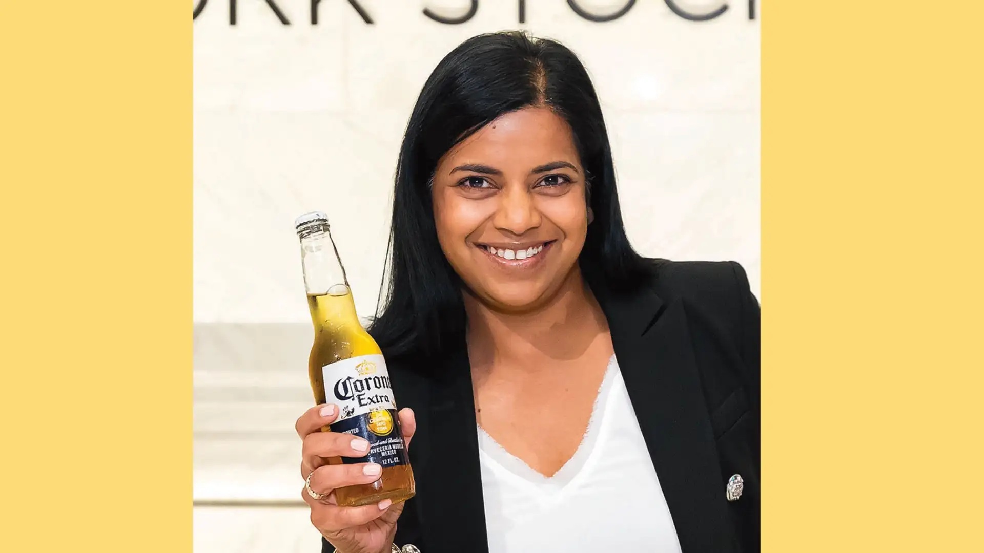 Mallika Monteiro holding a bottle of Corona Extra