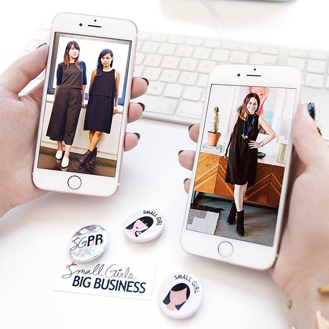 Small Girls PR colleagues pictured on two phones alongside agency badges