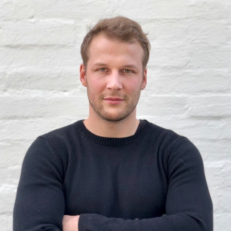 Malte Kramer seated in a modern office, wearing a black sweater