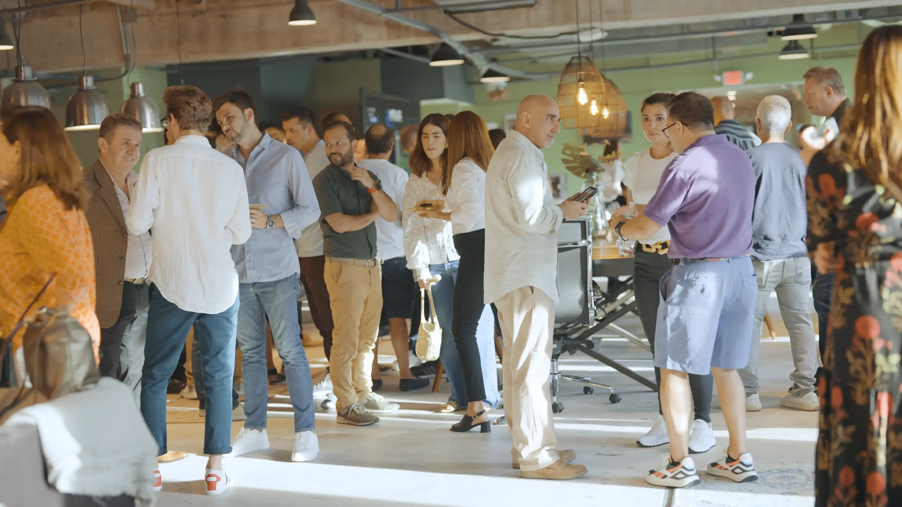 People talking in small groups at a Mana Tech community gathering