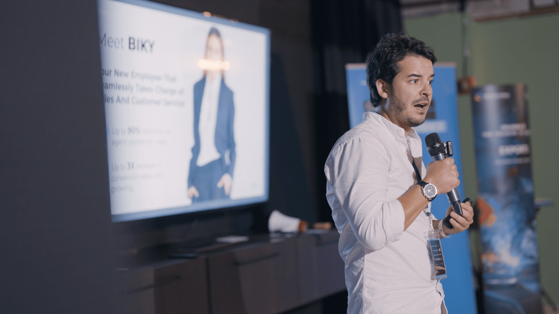 A founder presenting a business pitch with a microphone during Miami Immersion Demo Day