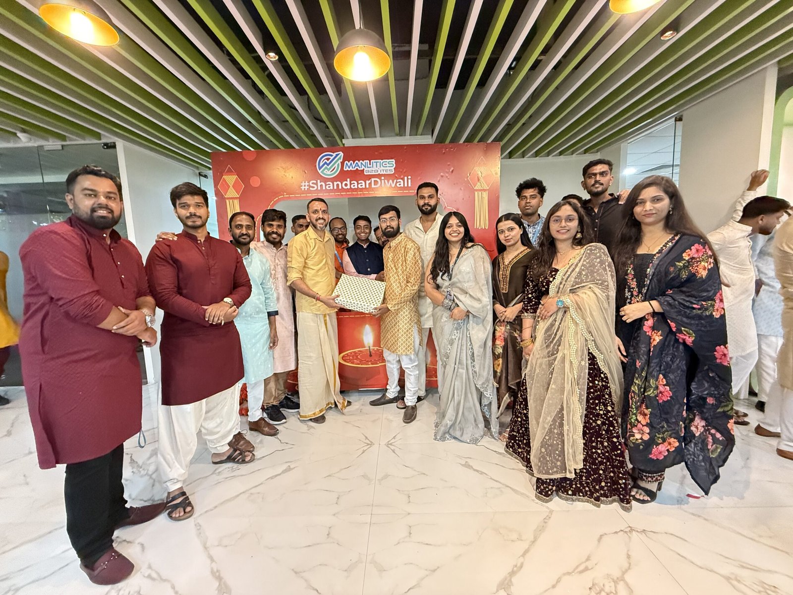 Manlitics colleagues gathered for a Diwali celebration in an office