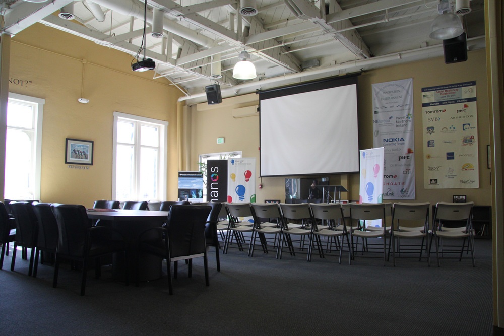 An archival Manos workspace with chairs facing a projection screen