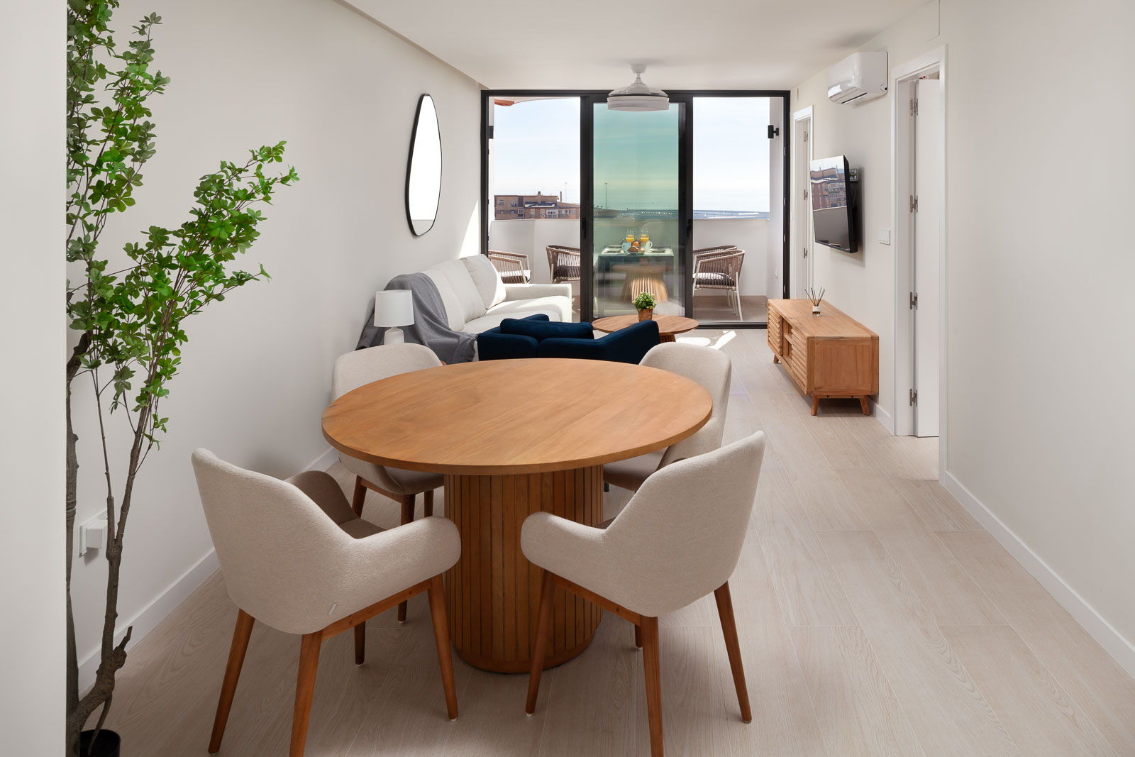 Living room of an Alta Homes apartment in Málaga, with a sofa and dining area