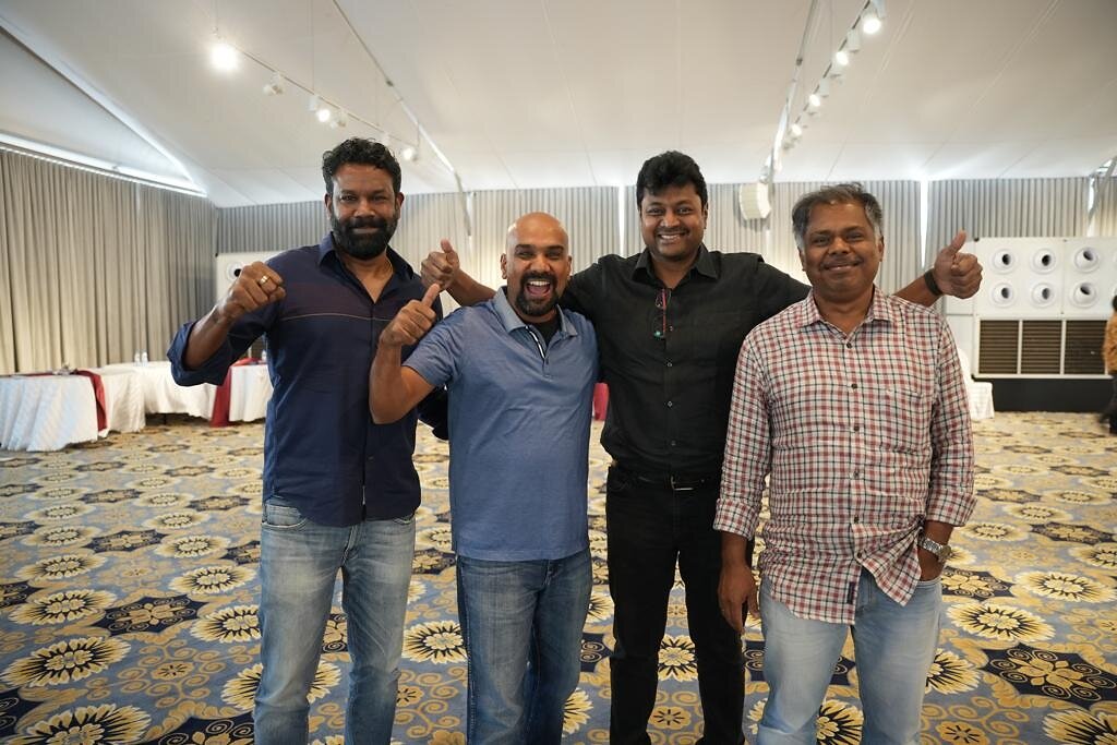 KaarTech’s four co-founders smiling together; Maran Nagarajan stands third from left
