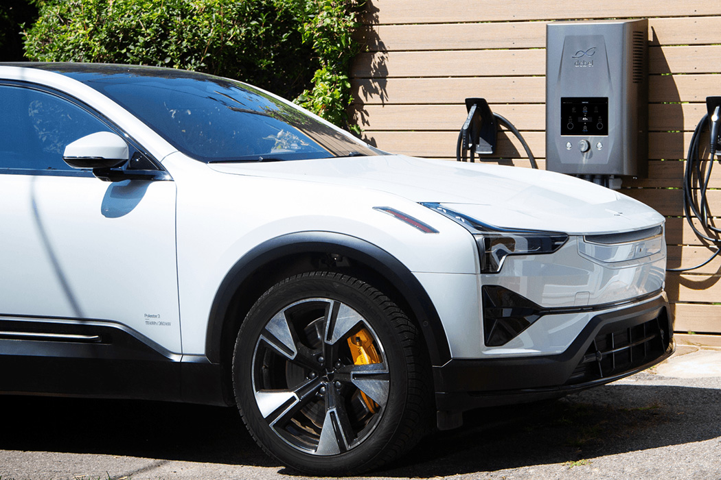 A Polestar 3 parked beside a wall-mounted dcbel home energy station