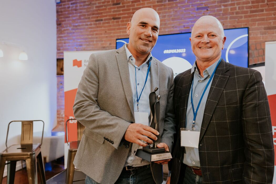 Marc-Antoine Cantin, left, holding the 2023 Angel of the Year Award beside Marcel Larochelle