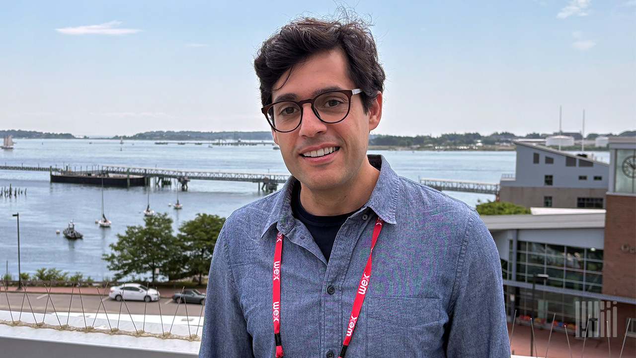 Marc El Khoury at WEX headquarters, with Portland harbor behind him