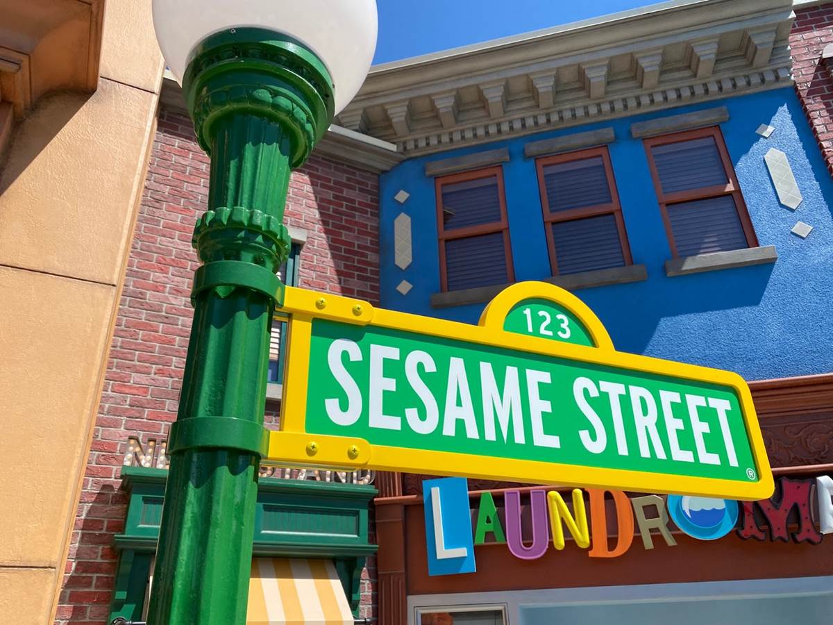The Sesame Street sign and colorful neighborhood buildings at Sesame Place San Diego
