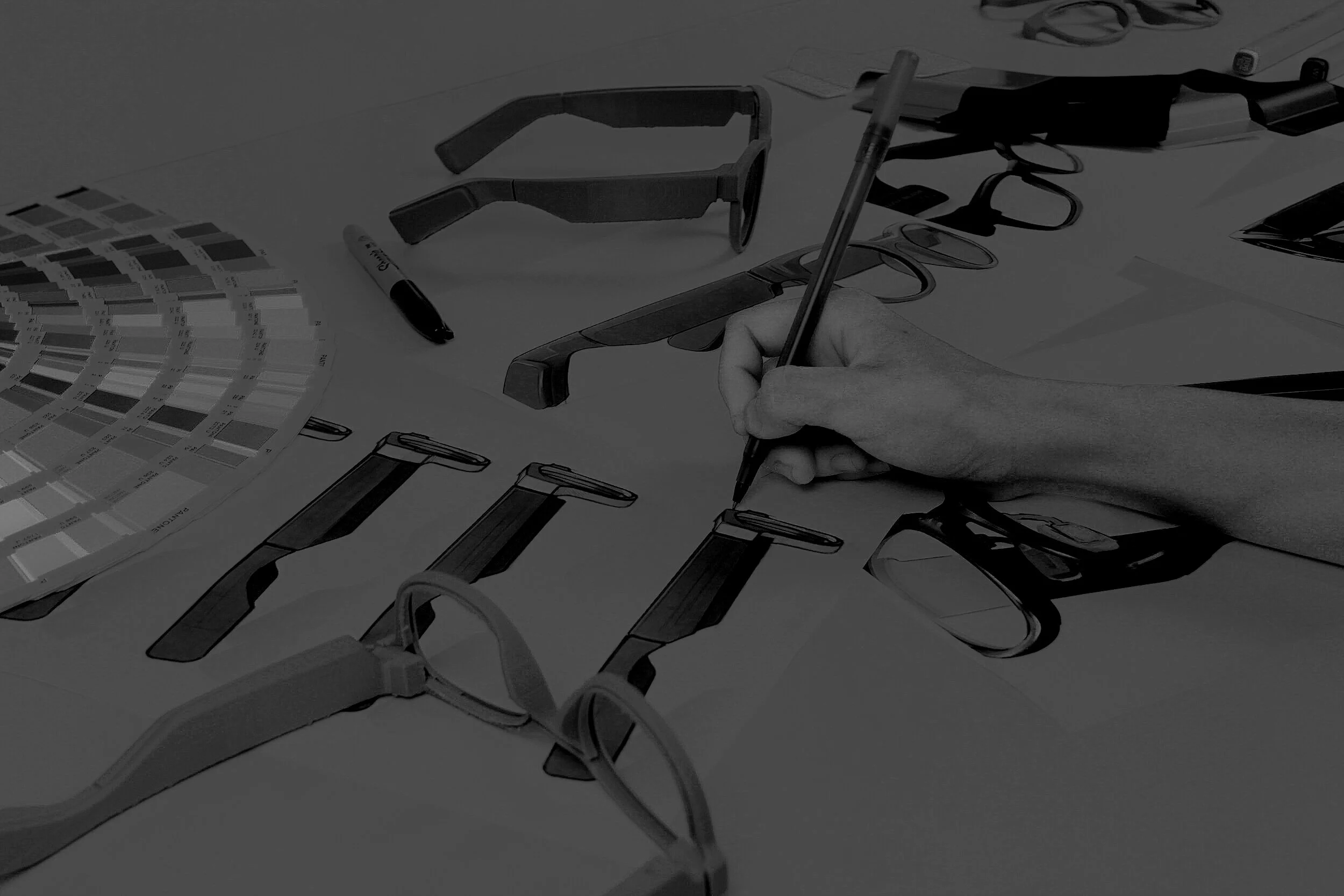 Eyewear sketches, prototype frames and color swatches on a Lifestyledesign work surface