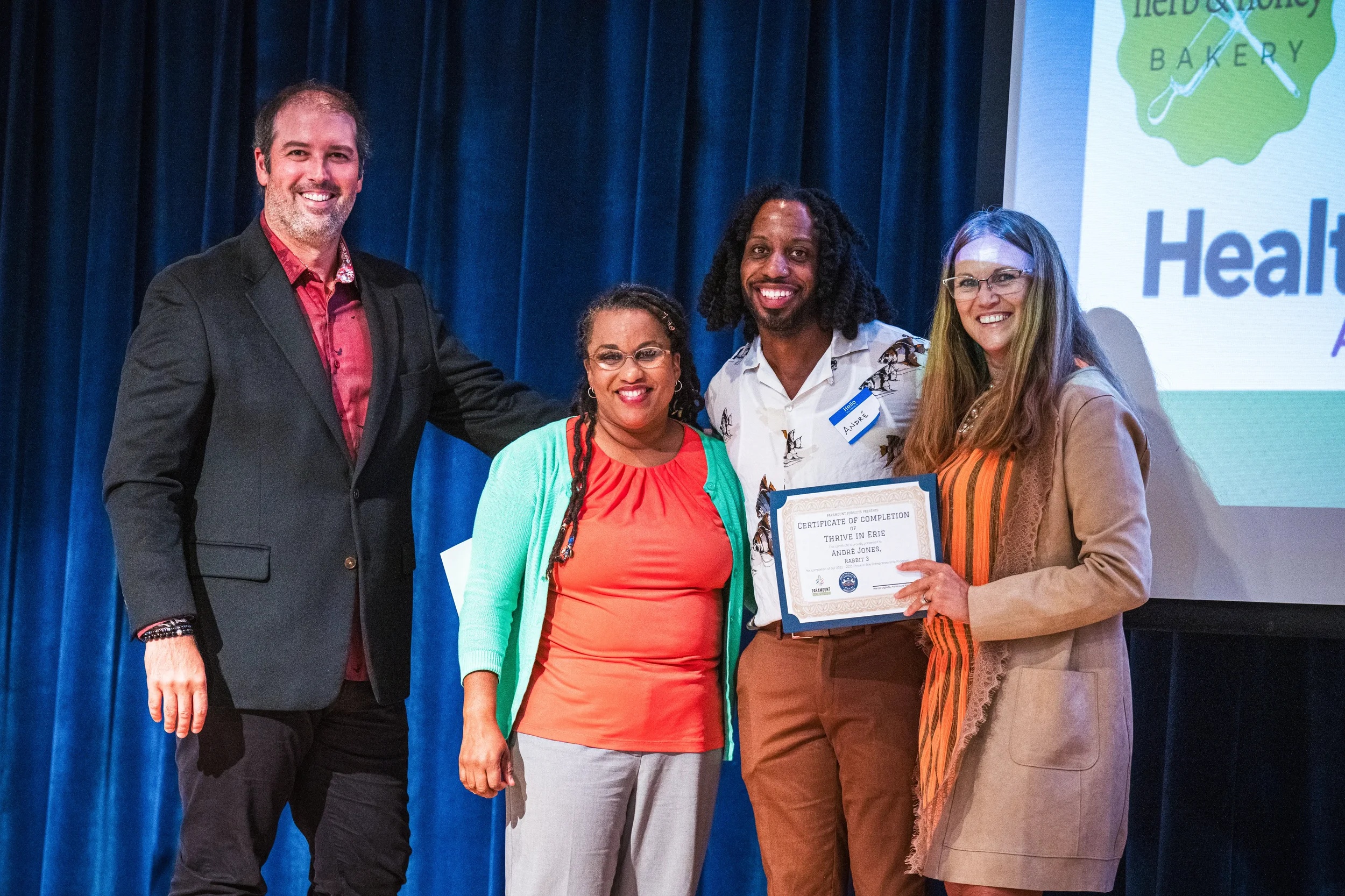 Marcos Digliodo, left, and Trish Digliodo, right, with participants at a Thrive in Erie certificate presentation
