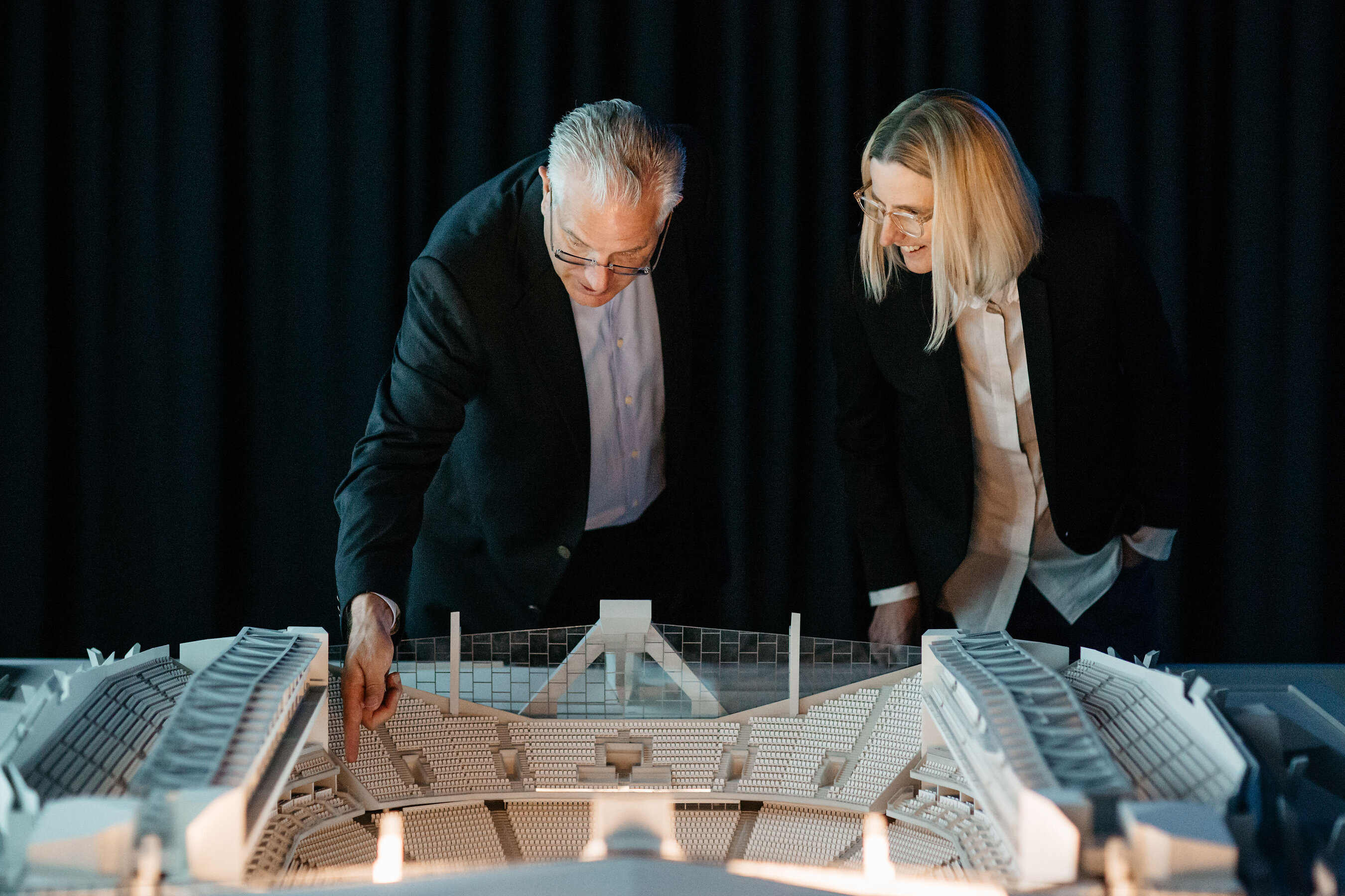 Tod Leiweke and Margaret Meister examine a model of Seattle’s planned arena.