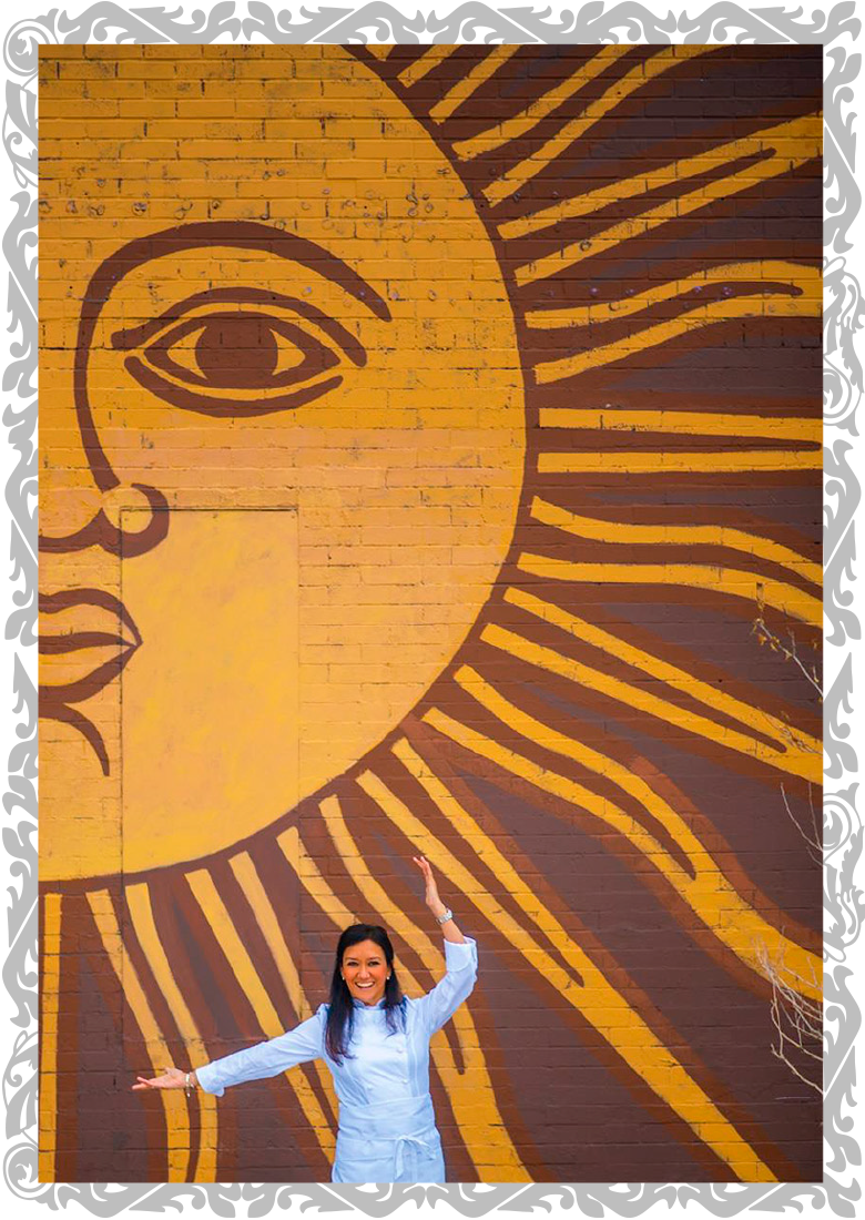 Lorena Cantarovici in front of the Maria Empanada sun mural