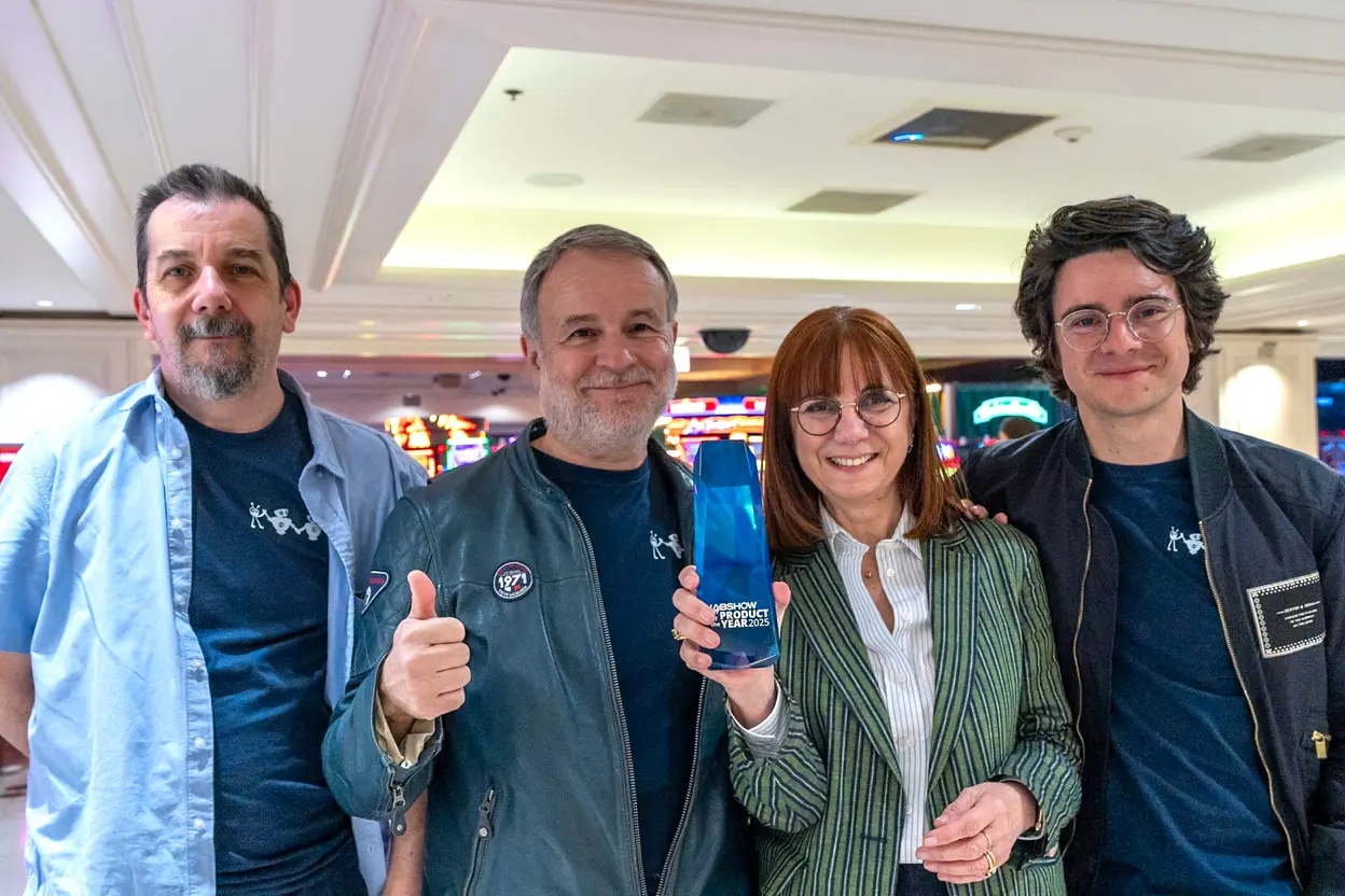 Marie-Véronique Lacaze with Witbe colleagues holding a blue NAB Show Product of the Year 2025 trophy