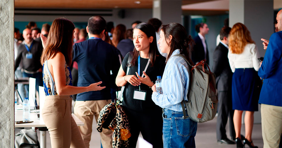 Participants talking in small groups at a Lanzadera Corporate Day event