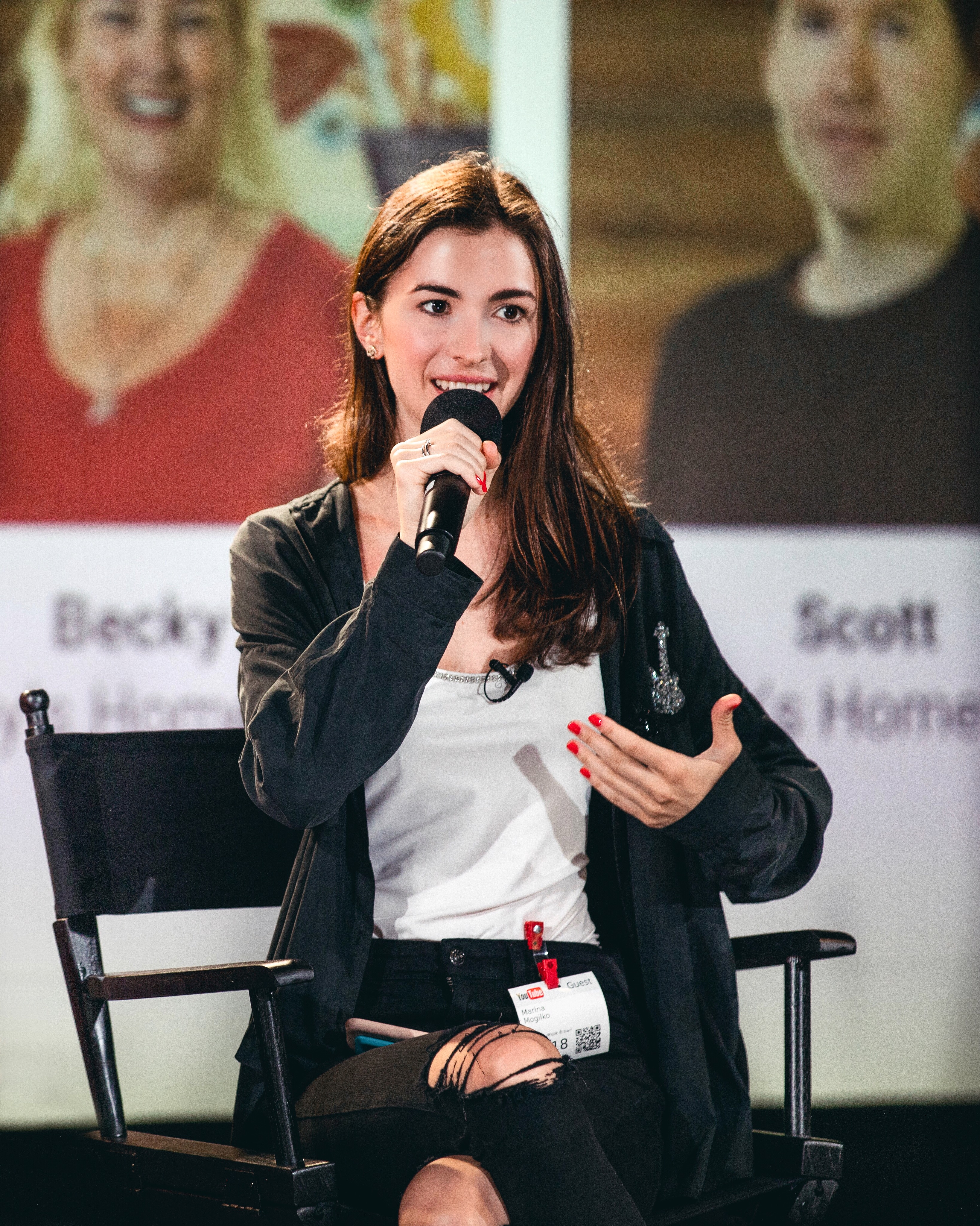 Marina Mogilko speaking into a microphone at YouTube Space in San Francisco in 2018