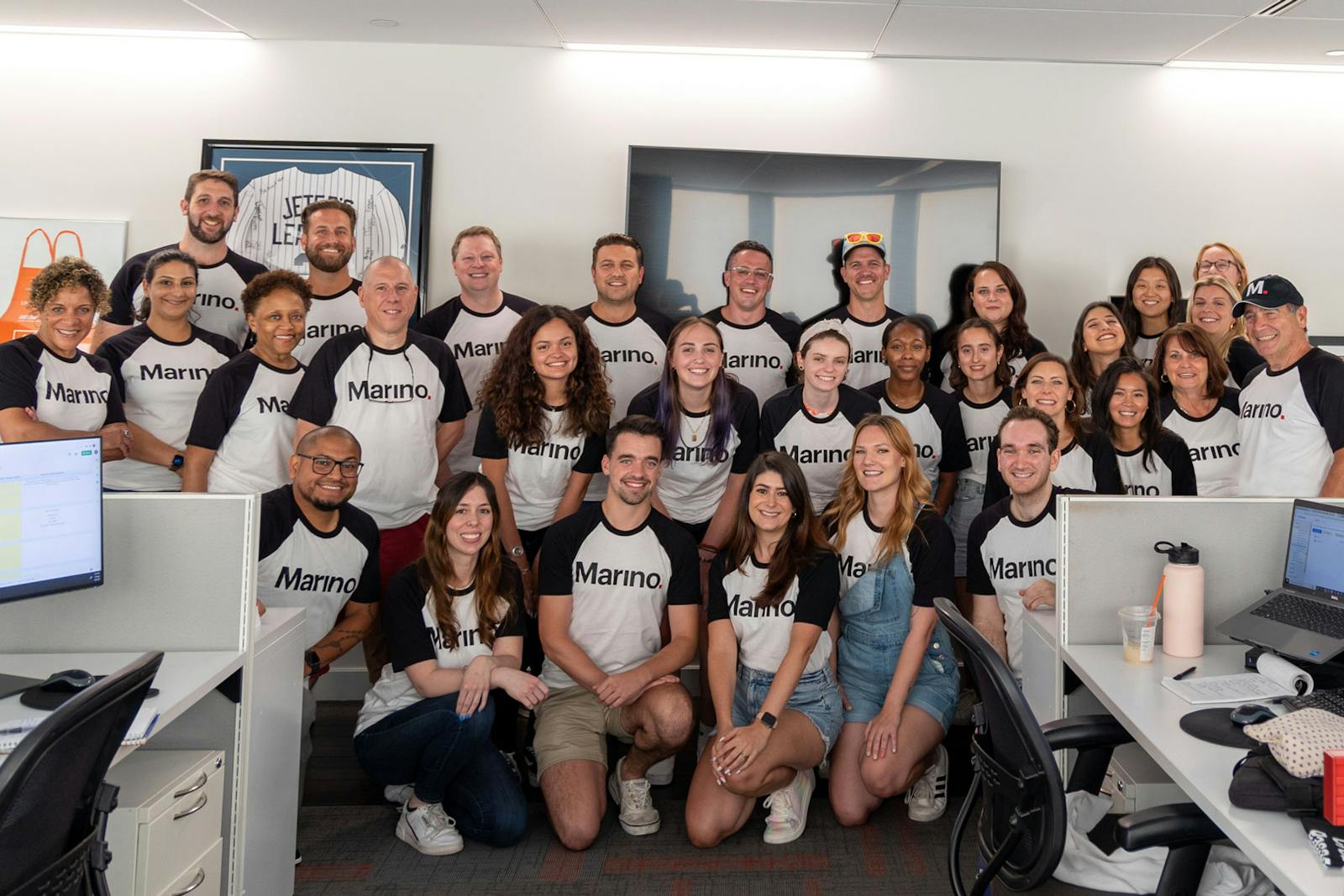 Members of the Marino team gathered in a bright office