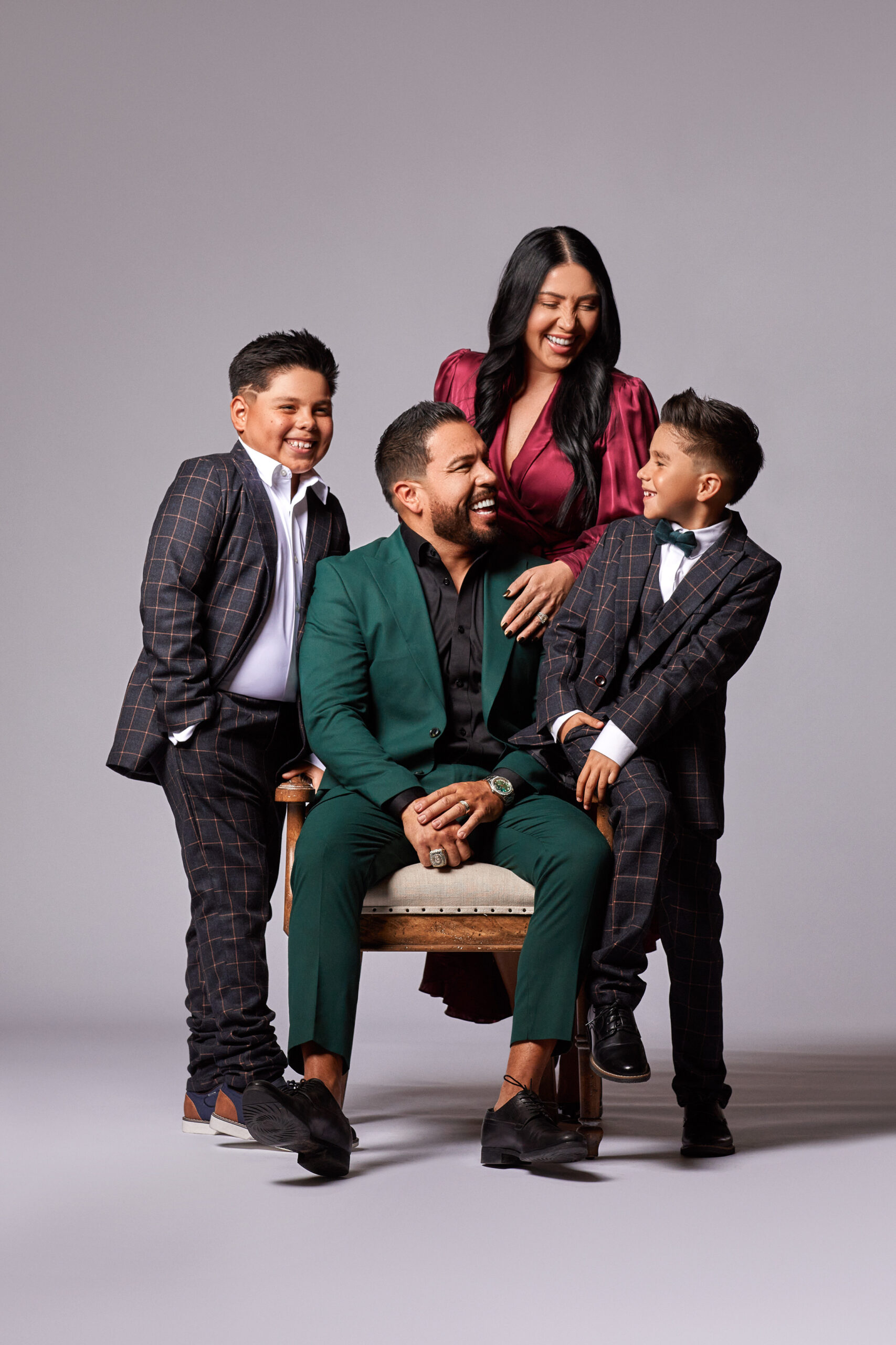 Mario and Franny Arrizon laughing with their two sons in a family photograph