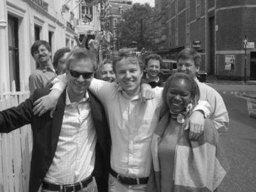 Skype colleagues celebrating a launch outdoors in Soho; Mark Asseily is in the group, identified as sixth from the left in the archival caption.