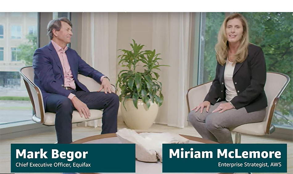 Mark Begor seated with AWS enterprise strategist Miriam McLemore during an interview