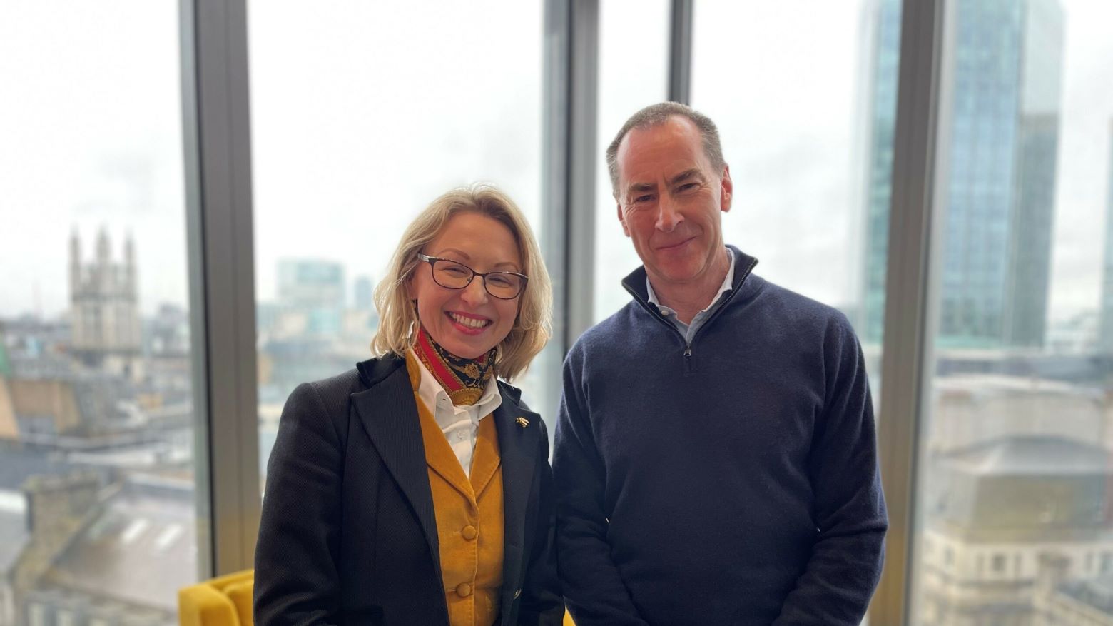 Guildhawk founder Jurga Zilinskiene, left, with Mark Brooks-Wadham, right, beside windows overlooking London.